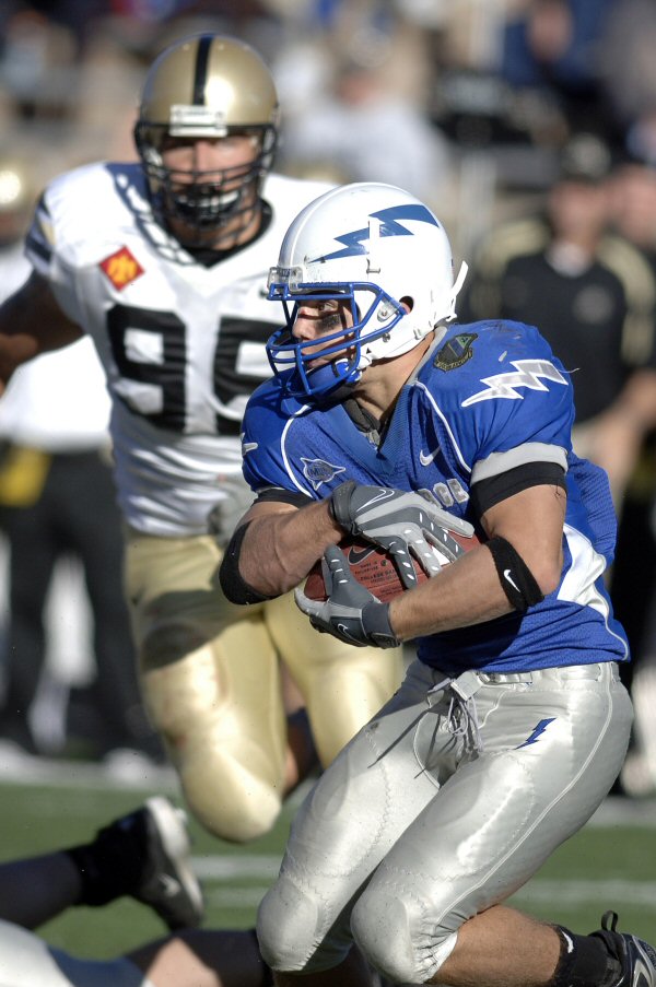 Air Force wide receiver Chad Hall tries to juke past an Army defender during the Falcons-Black Knights game at the U.S. Air Force Academy’s Falcon Stadium, Nov. 3, 2007. Now an Air Force Reserve officer and a wide receiver with the San Francisco 49ers, Hall is preparing for Super Bowl XLVII. U.S. Air Force photo by Mike Kaplan