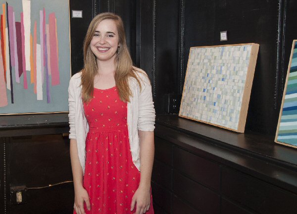 Carson-Newman’s Rachel Ramsey of Morristown stands with some of her work now on display at Jefferson City’s The Creek Café.  Art work by Ramsey, along with seniors Caitlyn Buchanan and Caroline Lawless, is the subject of two senior exhibits opened to the public this month.