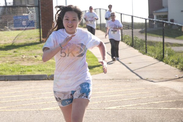 Runner Fiona Huang closes on the finish-line during C-N’s color run.  Huang was one of some 100 participants who took part in the event.