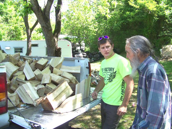 Bryce Smith volunteers his time to take truck loads of fire wood to needy families such as Dwight Boling who suffered a stroke in November - Staff Photo by Michael Williams