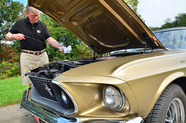 Carson-Newman University alumnus Bill Fletcher checks the oil on his '69 Mustang.  Fletcher plans to be on hand for Carson-Newman's "Blast to the Past" Cruise-In on Friday, Oct. 18.  The event is open to the public and is part of the University's Homecoming weekend celebration.