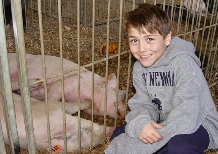 Conner Shrader with his 2013 Grand Champion Market Hog will also be participating in this year’s 4-H Market Hog Project