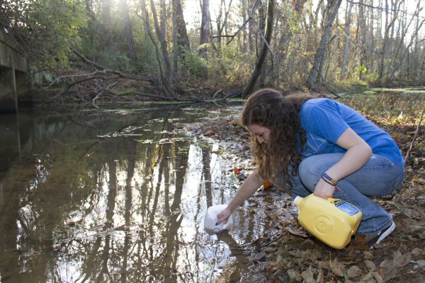 Kelli Snyder, a Carson-Newman freshman from Maryville, gathers water as part of a "water walk."  The event was part of Carson-Newman's Missions Emphasis Week.