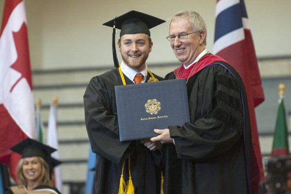 Jefferson City native Logan Hester, left, receives his Bachelor of Arts degree from Carson-Newman President Randall O’Brien.