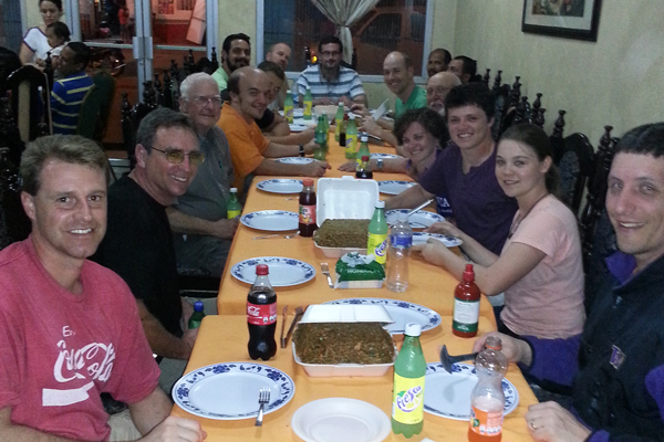 Group having dinner at a Chinese restaurant after a hard day of work at the construction site and going door-to-door witnessing in Rio Dulce. 