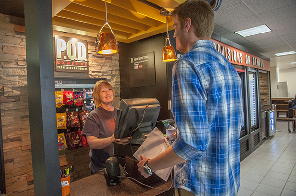 Aramark's Rita Heckard, greets senior Caleb Gibson at Carson-Newman's new POD Express kiosk.