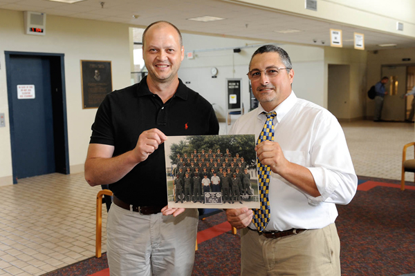 Allen Yokley, left, shows a picture of his 1985 basic training unit to Dr. Jeff Horner, dean of natural sciences at Walters State. Yokely saw action in Panama, Afghanistan and Iraq. Now, he’s using his G.I. Bill benefits to pursue a career in radiography.