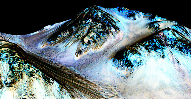These dark, narrow, 100 meter-long streaks called recurring slope lineae flowing downhill on Mars are inferred to have been formed by contemporary flowing water. Recently, planetary scientists detected hydrated salts on these slopes at Hale crater, corroborating their original hypothesis that the streaks are indeed formed by liquid water. The blue color seen upslope of the dark streaks are thought not to be related to their formation, but instead are from the presence of the mineral pyroxene. The image is produced by draping an orthorectified (Infrared-Red-Blue/Green(IRB)) false color image (ESP_030570_1440) on a Digital Terrain Model (DTM) of the same site produced by High Resolution Imaging Science Experiment (University of Arizona). Vertical exaggeration is 1.5.Credits: NASA/JPL/University of Arizona