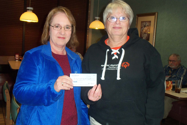 Joan Spoon, Treasurer, presents a charity check to  Teresa Cloninger of the local Special Olympics.