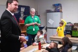 REP FARMER DELIVERS BLUE BOOKS TO DES STUDENTS